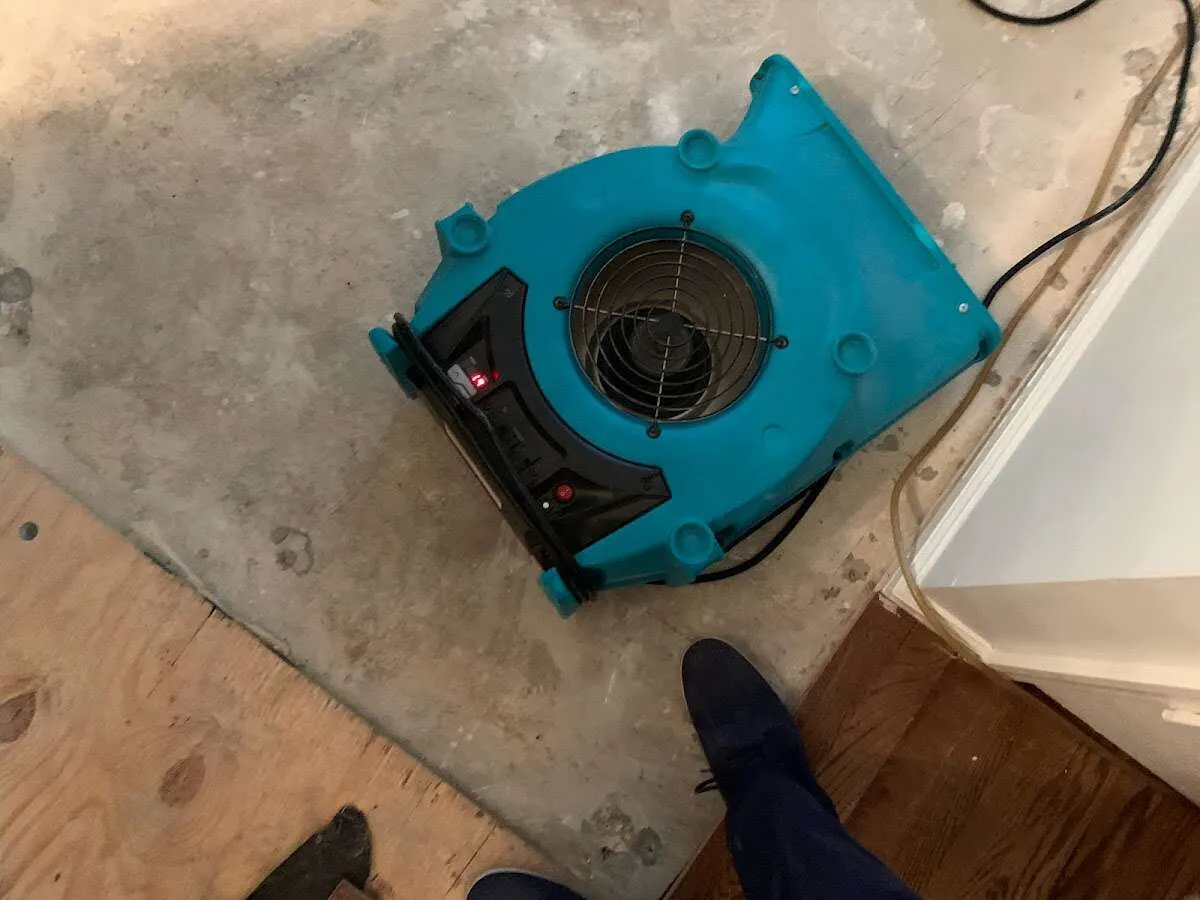 Air mover drying subfloor during Commercial Water Damage Restoration in Schertz